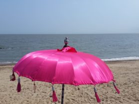 Pink parasol on the beach at Felixstowe